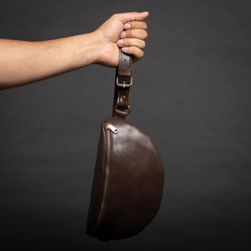 hand holding brown fanny pack