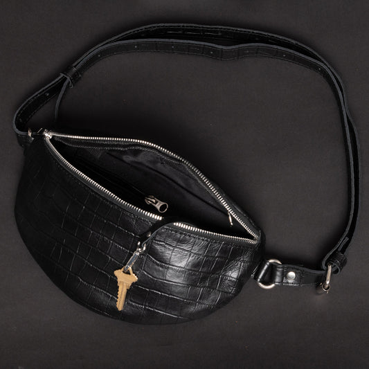 crocodile print black fanny pack with key hanging outside